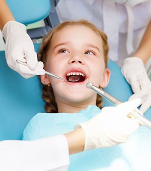 Young girl getting her teeth cleaned